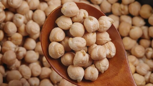  Macro close up of chickpeas in a wooden spoon