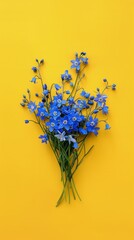 A bouquet of blue flowers on a bright yellow background