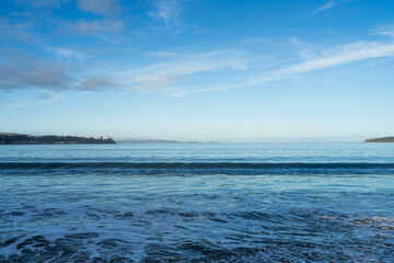 beautiful waves rolling in on a sandy beach in winter in Tasmania Australia