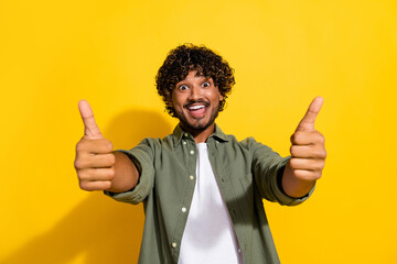 Portrait photo of young funny mexican guy in khaki shirt showing like rating to you invite to party...