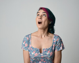a close up head and shoulders portrait of young alternative female model, with pink and grey shaved...