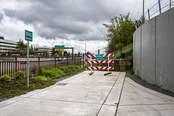 Mountains to Sound greenway trail section in Eastgate, trail end barricade and direction sign, cement trail for outdoor recreation
