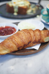 fresh baked croissant on plate with copy space 