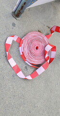 The Red and white  Warning Tape or security band prepared to block off dangerous areas. A roll of...