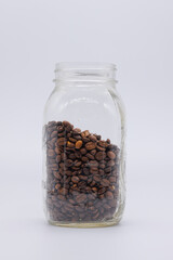 Glass Mason Jar with Freshly Roasted Coffee Beans on white background