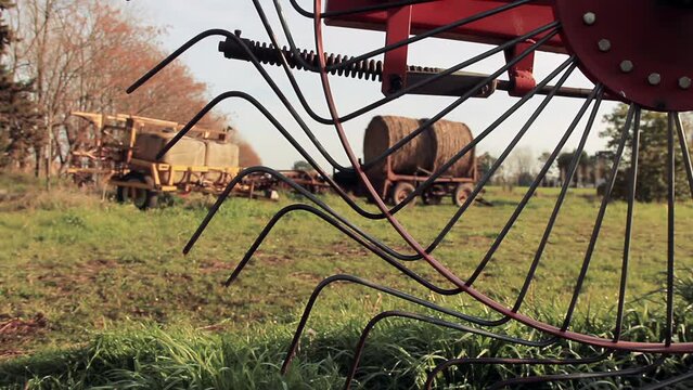 Rusty Farm Equipment in Rural Field, Antique Hay Rake and Countryside Scene, 4K