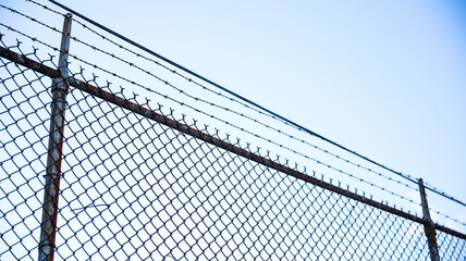 chain fence with blurred background, representing confinement and restriction