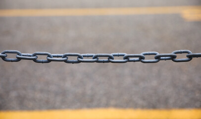 chain fence with blurred background, representing confinement and restriction