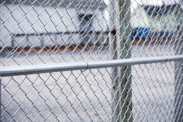 chain fence with blurred background, representing confinement and restriction