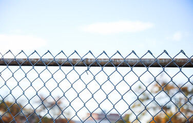 chain fence with blurred background, representing confinement and restriction