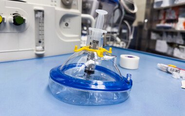 hospital airway equipment including a laryngoscope, airway mask, and oxygenation tools, symbolizing medical care and anesthesia
