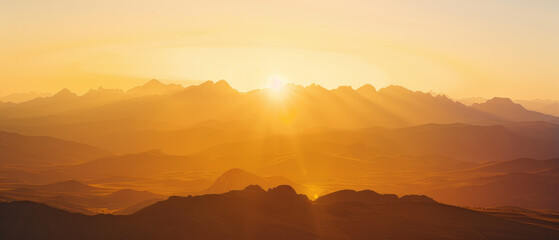 Golden Hour Sunrise Over Silhouetted Mountain Range