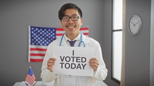 Asian man in lab coat holding 'i voted today' sign in usa themed room