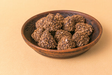Rustic Wooden Plate of Homemade Chocolate Oatmeal Cookies on Beige Background