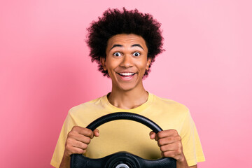 Photo of funky astonished person toothy smile hands hold wheel isolated on pink color background