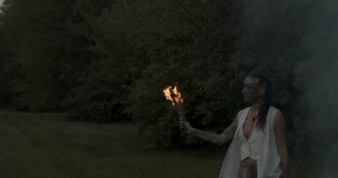 The vibrant energy of Beltane! This video captures the spirit of the Celtic fire festival with a focus on a woman adorned with beautiful face paint, dancing in the warm glow of the bonfire.