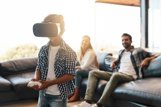 Family, child and virtual reality headset in home for cyber experience, metaverse system or gaming connection. Gamer parents, boy and VR games in living room with future, innovation and ui technology