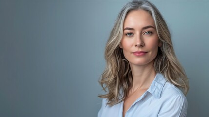 Fototapeta premium A woman with long blonde hair and blue shirt.