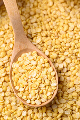 Yellow peeled split mung bean in wooden spoon, Food ingredient