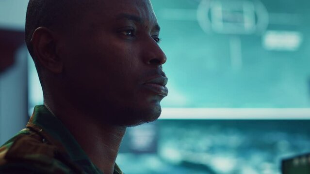 Lieutenant colonel gathering intelligence from federal radar systems, working with his crew in military command control room. Examining satellite imagery for reconnaissance mission. Camera A.