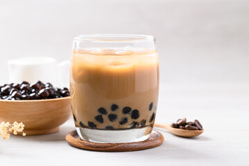 Iced coffee latte milk bubble tea in glass with white background, Asian drink