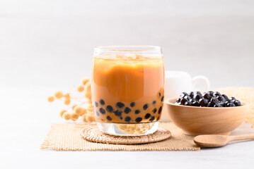 Iced Thai milk tea with boba or Thai bubble tea in glass on white background