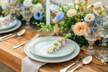 Beautiful table setting with flowers and cutlery on wooden table at wedding or dinner. stylish tableware decorations