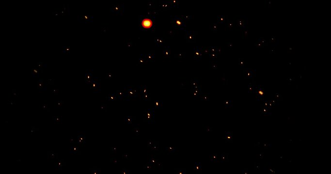 Realistic surreal ember fire dust slowing rising up on black bg 4K. Grunge dark fire sparks flying isolated on dark background. Overlay spark tiny flake burning animation. Hell rising burst inferno.