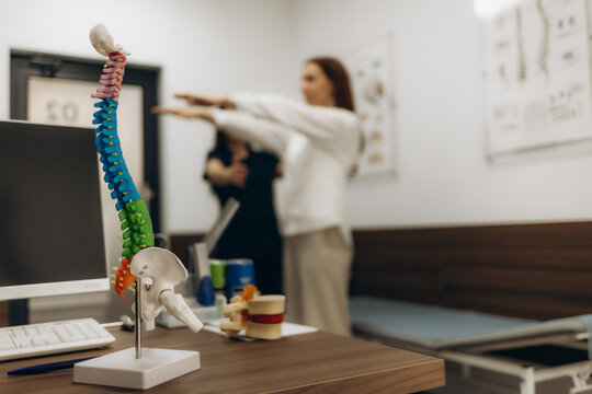 Doctor neurologist checks the reflexes of the patient Woman with eyes closed and her arms outstretched in front of her at a medical appointment