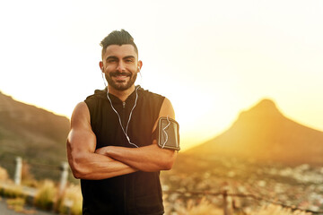 Fototapeta premium Portrait, man and happy with earphones in countryside for music and exercise in summer. Mountain, athlete and bodybuilder in nature for wellness and workout with fitness and podcast in Los Angeles