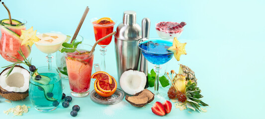 Summer colorful cocktails on blue background. Fresh tasty tropical drinks