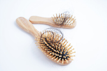 Hair loss fall with comb brush isolated on white background.