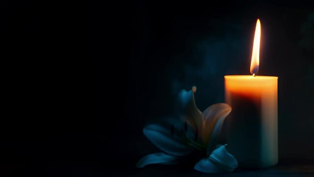Lit candle  lily on dark backdrop suited for text funeral symbol. Concept Funeral symbolism, Candle and lily, Dark backdrop, Text appropriate, Grief and mourning