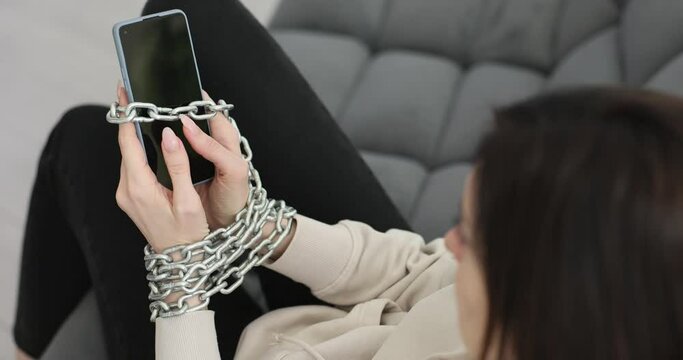 Handcuffed hands holding smartphone and phone scam