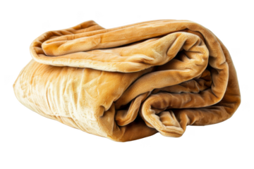 A large, fluffy, tan blanket is laying on a white background