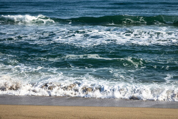 View of the surfs on the sand beach
