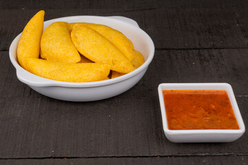 Delicious traditional Colombian empanadas with spicy sauce