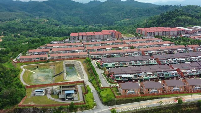 Aerial views, drone flyover the Goodview Heights residential neighborhood featuring rows of double-storey terraced houses constructed by SHL Consolidated Berhad, in Kajang, Malaysia, Southeast Asia.