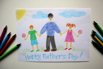A Father's Day card drawn by a child. White background. Colored pencils near the postcard. The card...