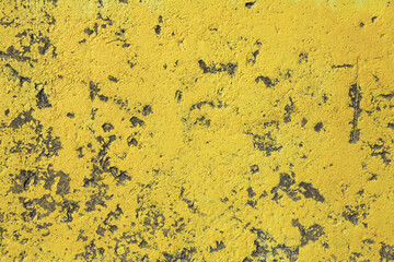 Yellow concrete wall, texture, background. Old textured wall, painted in yellow. Surface of concrete slab or supporting wall. Destroyed, chipped from age hydraulic concrete. Abstract, rough backdrop