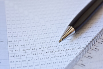 Luxury pen close up shot on spreadsheet table list, blurred background