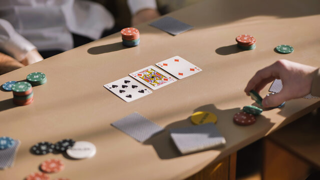Young guys playing poker at a table.