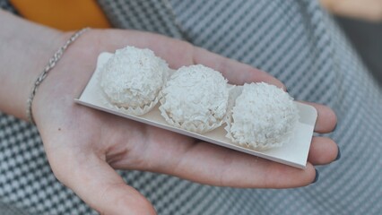 Three coconut candies on the girl's arm.