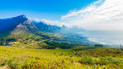 Panoramic view of Camps Bay and Bakoven with Table Mountain and the Twelve Apostles covered with clouds, Cape Town, South Africa