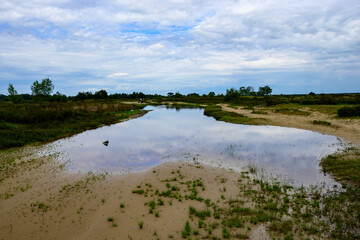 photo of a wide hiking trail that has been flooded by too much rain, in an open natural landscape. Grenspark de zoom - Kalmthoutse heide, Belgium