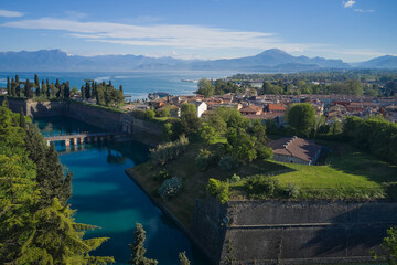 Obraz premium Aerial view of the town of Peschiera del Garda located on the shores of Lake Garda. Resorts on Lake Garda Italy. Aerial panorama on the lake. City on the water Italy. The largest lake in Italy.