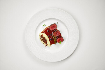 Medium-rare venison steak with mashed potatoes on a plate