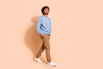 Full size photo of nice guy dressed blue pullover hold hands in pockets look at sale empty space...