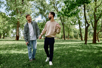 Naklejka premium A bearded gay couple walks hand-in-hand through a lush green park on a sunny day, their smiles radiating love and happiness.