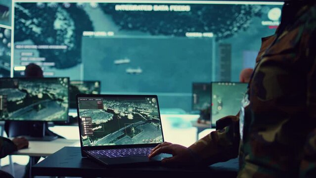 Navy operations specialist examines ships along the coast line to ensure national safety, employing CCTV satellite radar system for reconnaissance and protection. Military personnel. Camera B.